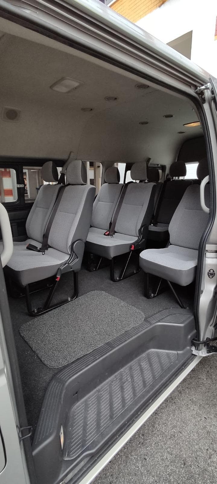 Interior row seating and luggage space in Mesa Travels maxi cab